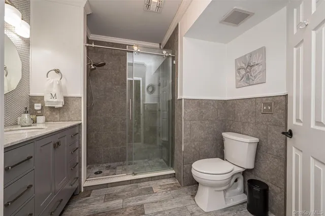 a bathroom with a toilet sink and shower