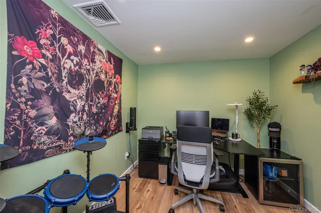 a view of a workspace with furniture and wooden floor