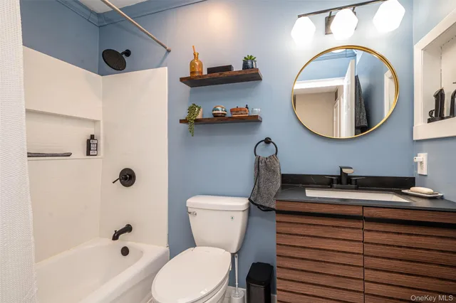 a bathroom with a sink a toilet and a mirror