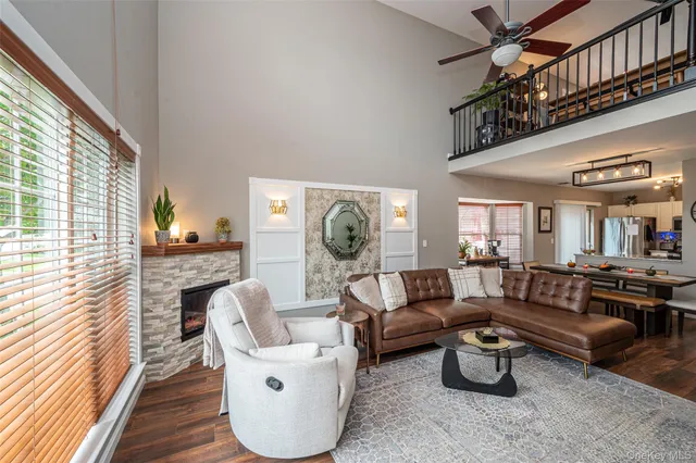 a living room with furniture a rug and a window