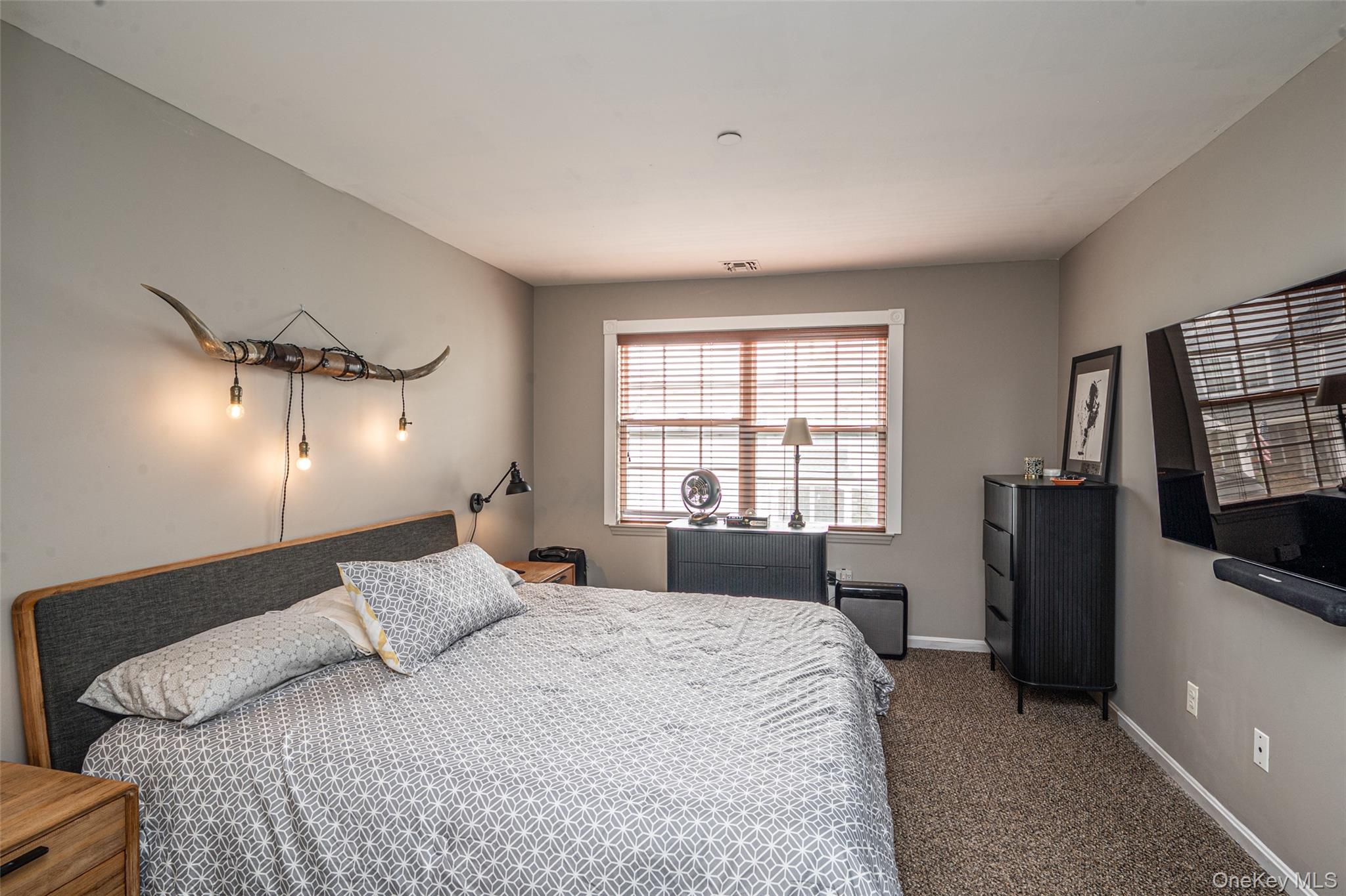 1 Casey Lane Middle Island, NY 11953 - Photo 21 of 35 a bedroom with a bed a flat screen tv and a large window
