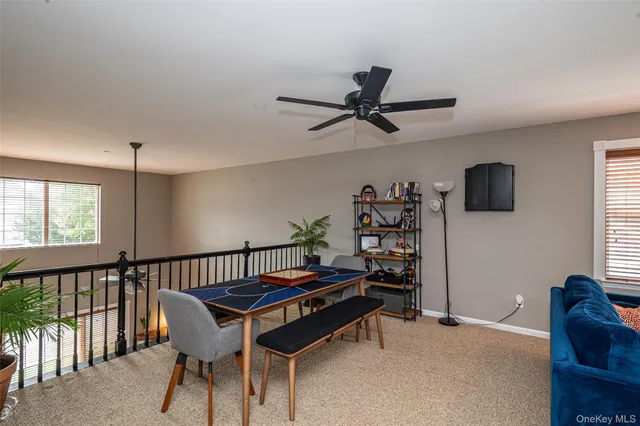 a living room with furniture a window and a flat screen tv