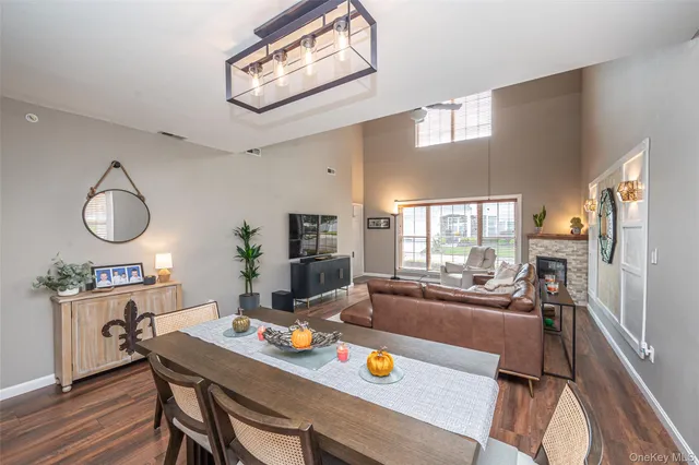 a view of a dining room with furniture a chandelier and wooden floor