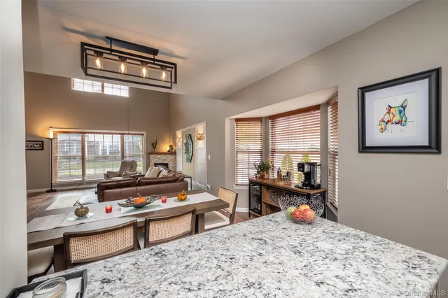 a living room with furniture a rug and a large window