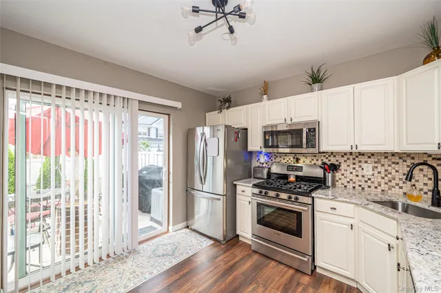 a kitchen with stainless steel appliances a stove a sink and a refrigerator
