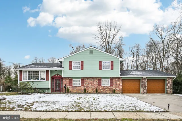 a view of a brick house with a bench and roof