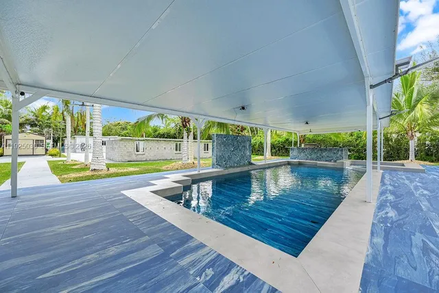 a kitchen with stainless steel appliances a refrigerator sink and cabinets