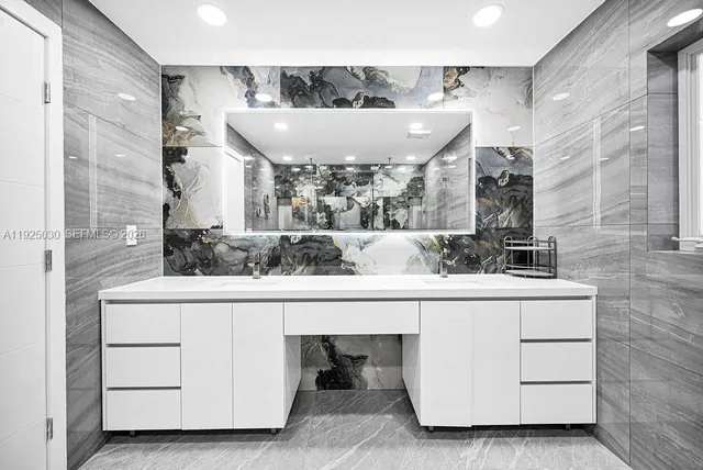 a bathroom with a sink a mirror and a toilet