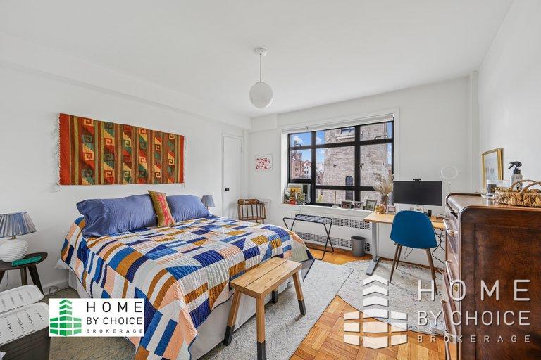 100 Remsen Street, Unit 8A Brooklyn, NY 11201 - Photo 9 of 14 a bedroom with a bed a couch and a dresser next to a window