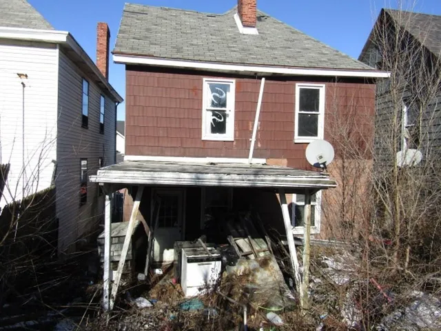 a view of a house with roof deck and furniture