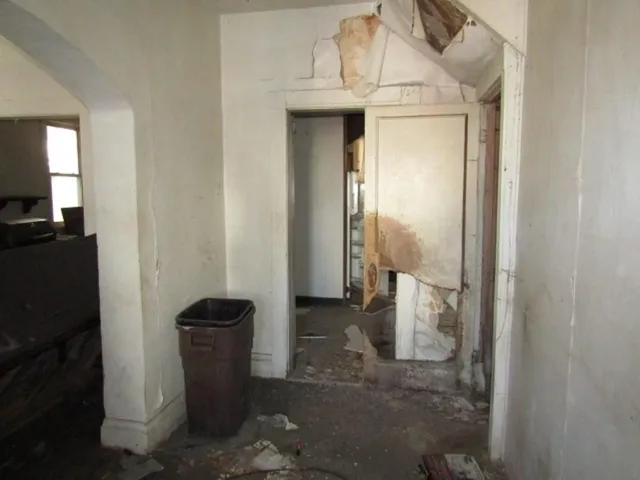 a view of a hallway with wooden cabinets and a floor to ceiling window