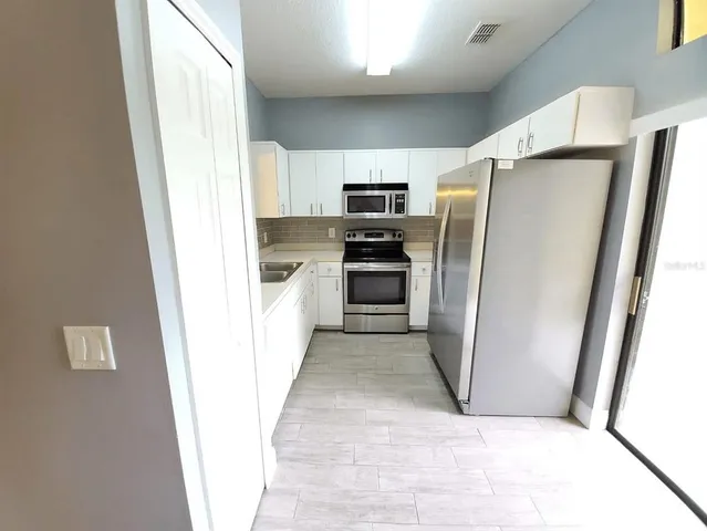 a kitchen with a refrigerator a sink and dishwasher