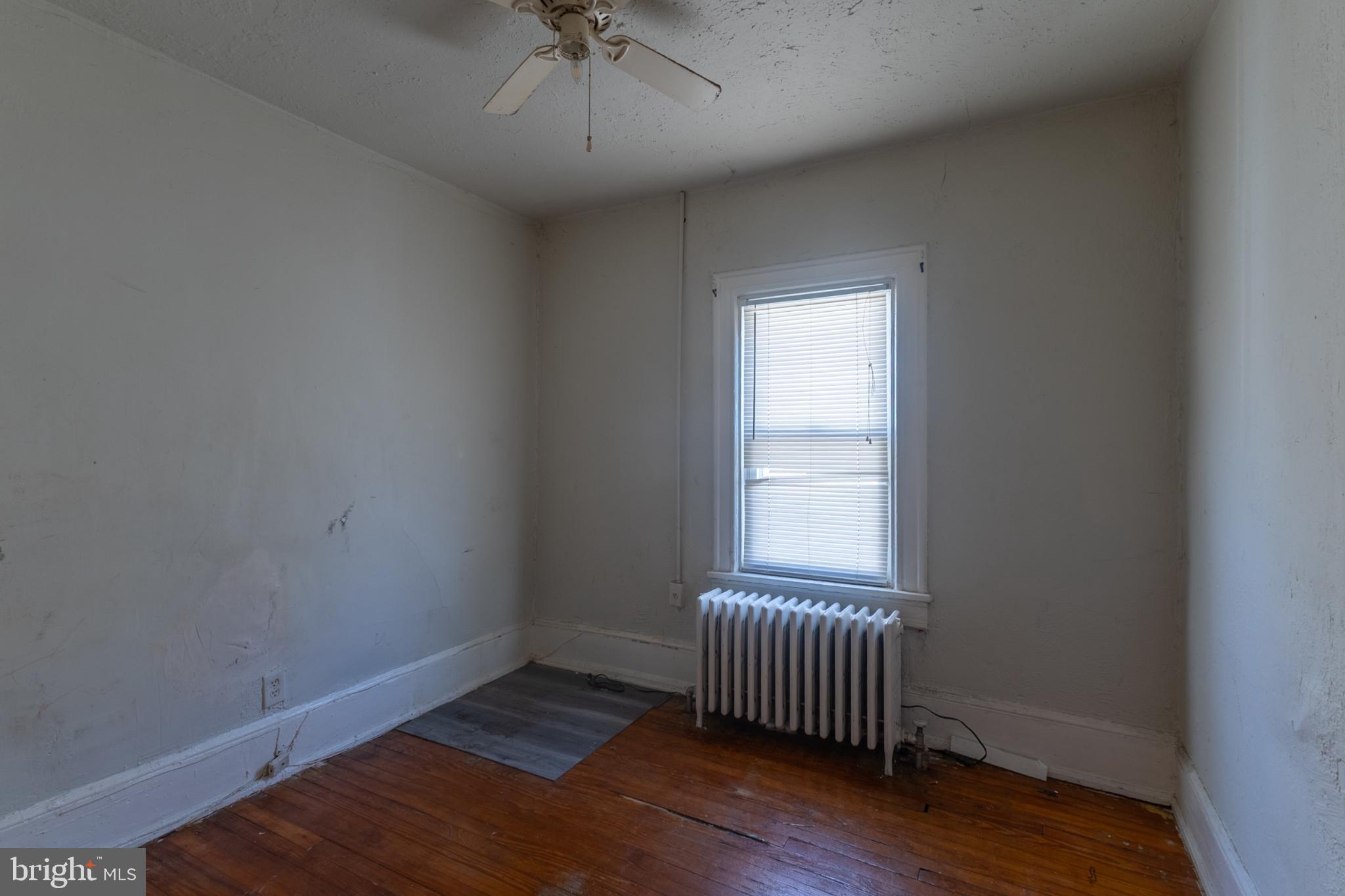 5911 Crown Street Capitol Heights, MD 20743 - Photo 13 of 28 an empty room with wooden floor and windows