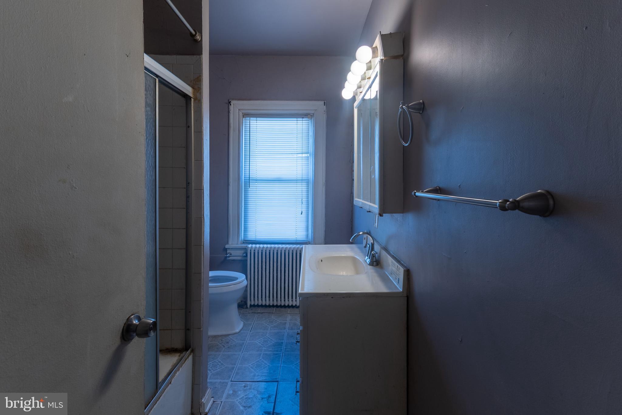 5911 Crown Street Capitol Heights, MD 20743 - Photo 14 of 28 a bathroom with a granite countertop sink a toilet and a mirror