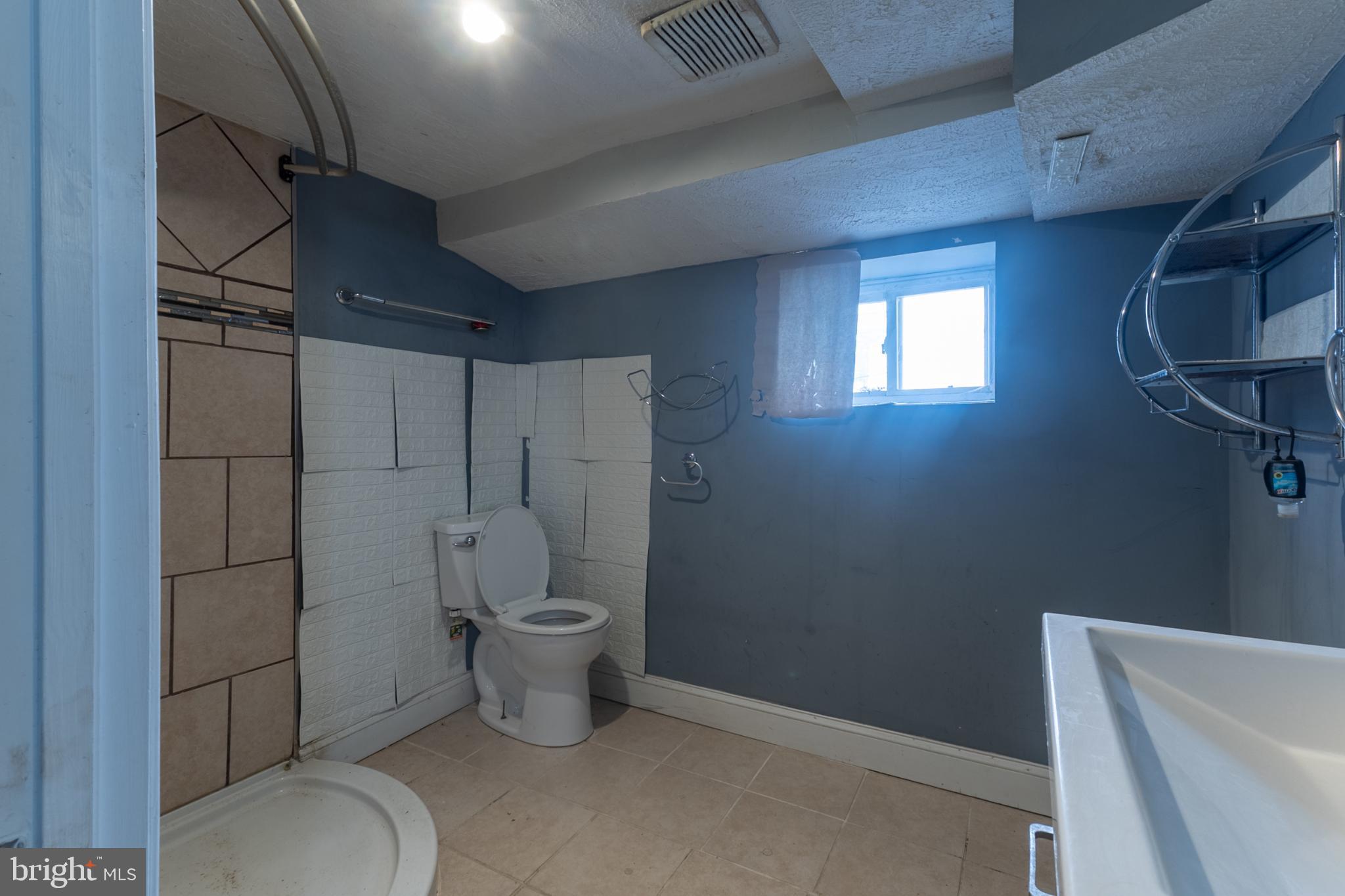 5911 Crown Street Capitol Heights, MD 20743 - Photo 18 of 28 a bathroom with a toilet and a shower