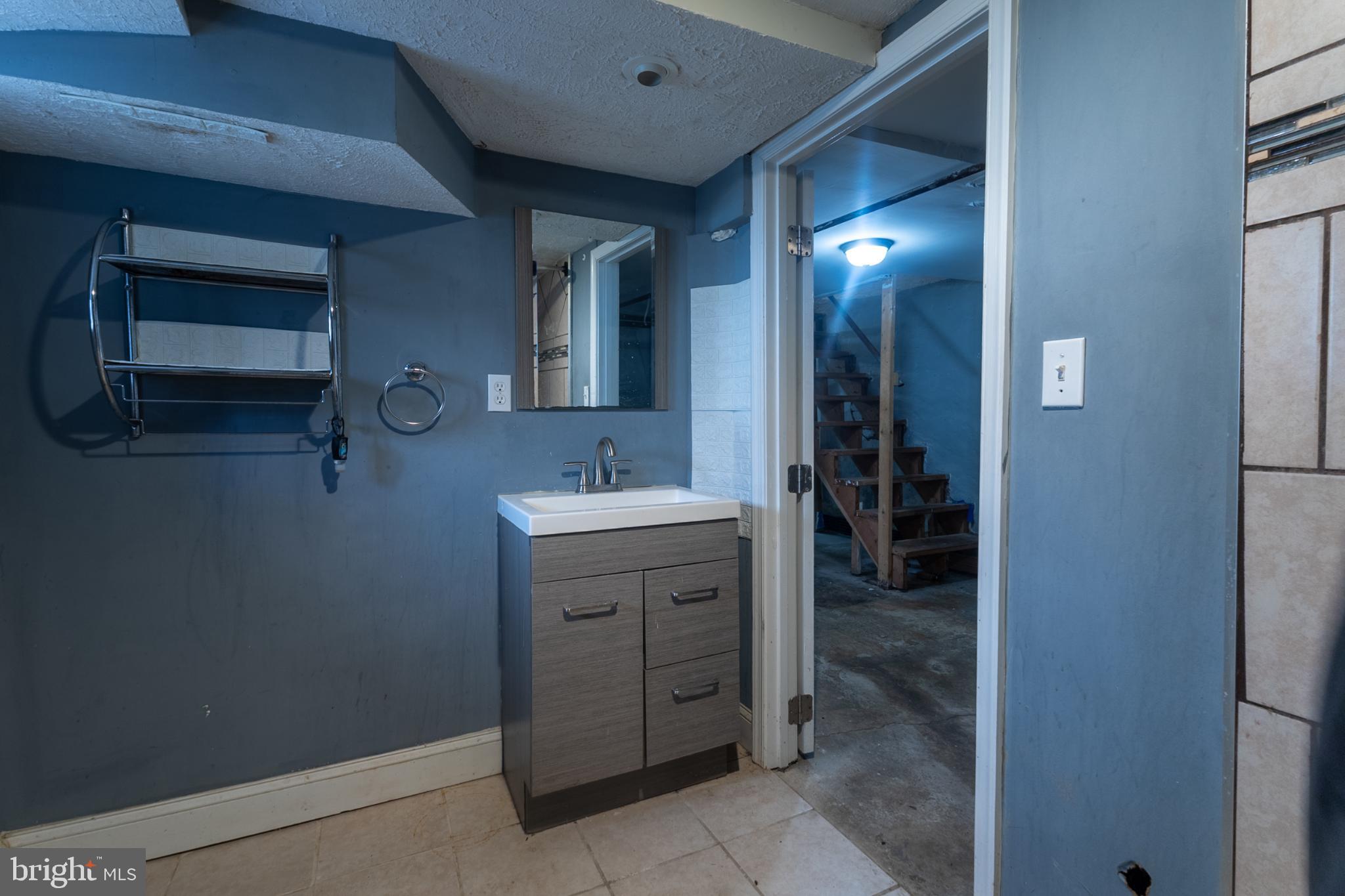 5911 Crown Street Capitol Heights, MD 20743 - Photo 19 of 28 a bathroom with a sink and mirror