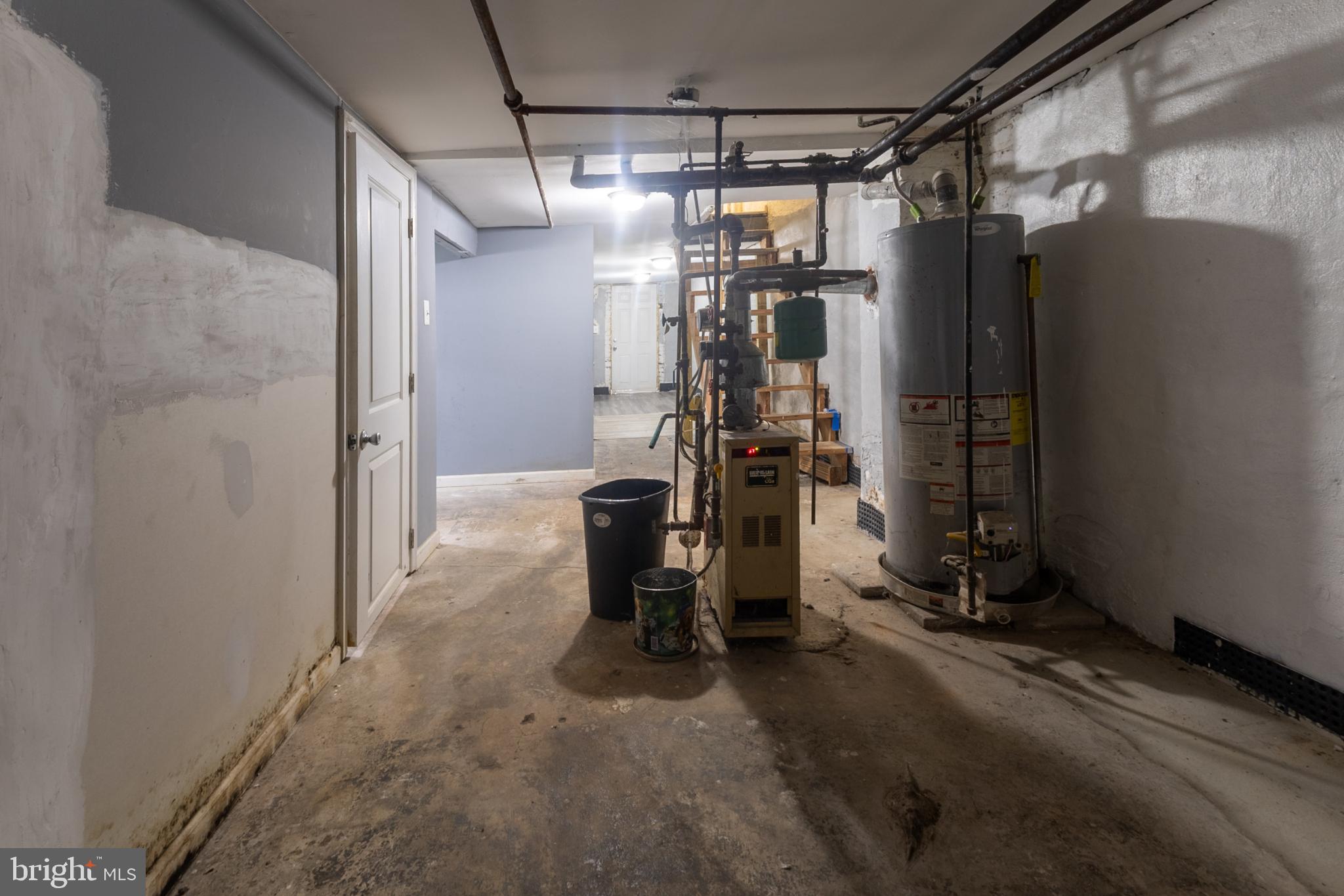 5911 Crown Street Capitol Heights, MD 20743 - Photo 24 of 28 a view of a storage room with water heater and racks