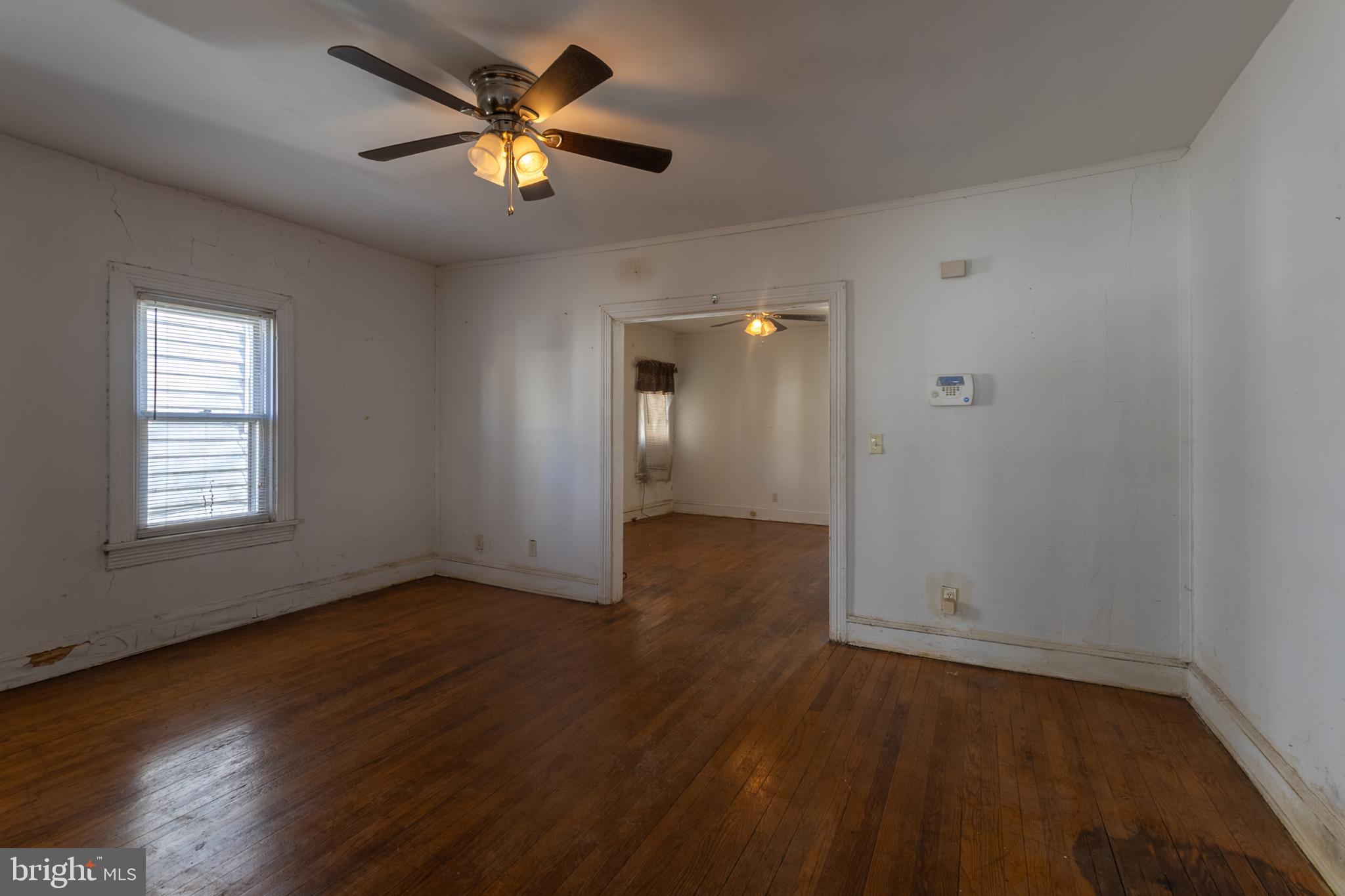 5911 Crown Street Capitol Heights, MD 20743 - Photo 4 of 28 an empty room with wooden floor and windows