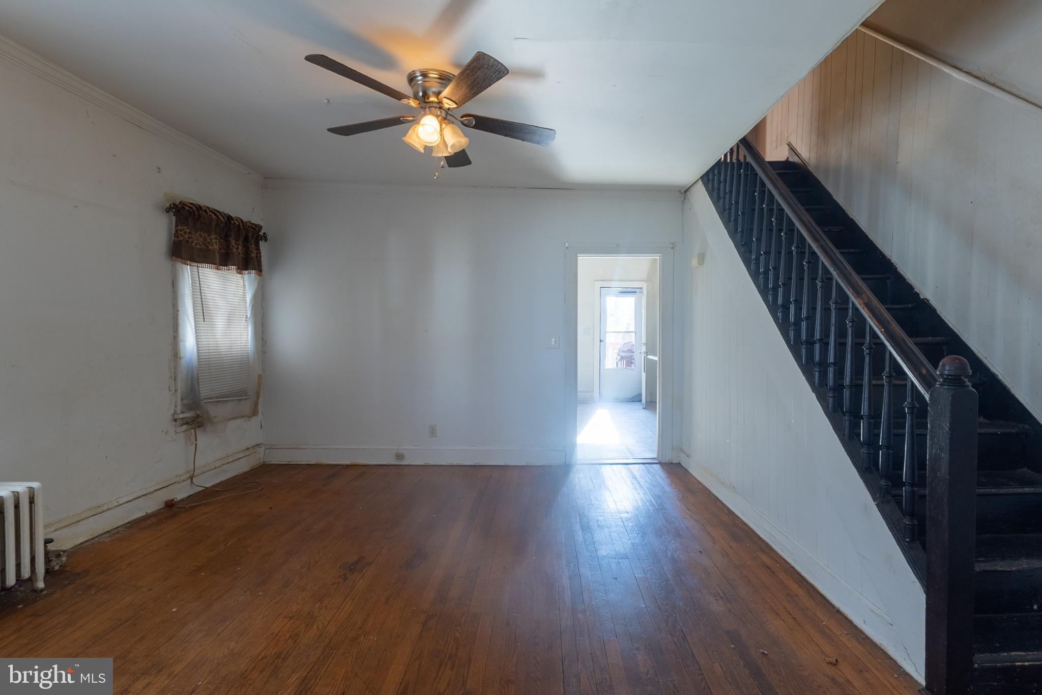 5911 Crown Street Capitol Heights, MD 20743 - Photo 5 of 28 wooden floor in an empty room with a window