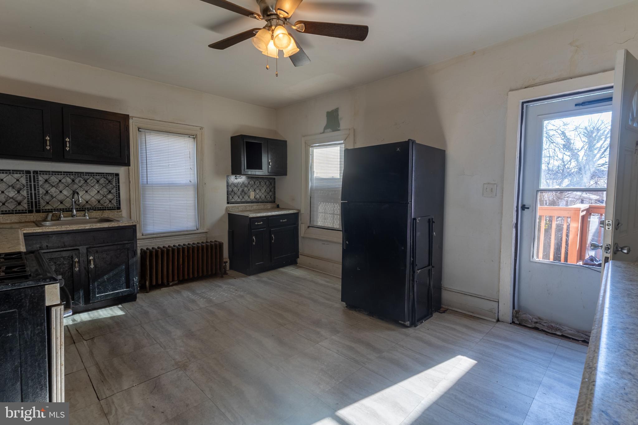 5911 Crown Street Capitol Heights, MD 20743 - Photo 7 of 28 a kitchen with stainless steel appliances granite countertop a refrigerator and a sink