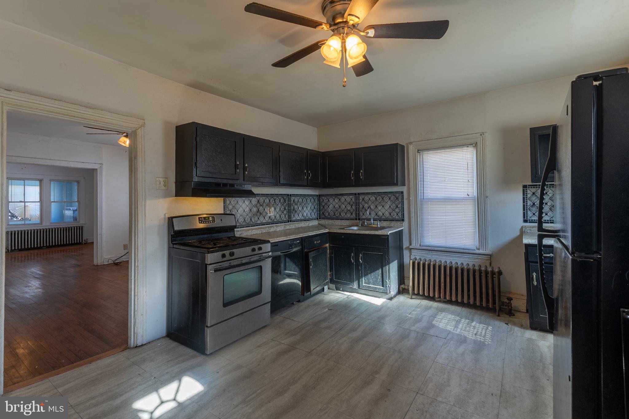 5911 Crown Street Capitol Heights, MD 20743 - Photo 9 of 28 a kitchen with stainless steel appliances a stove cabinets and a wooden floor