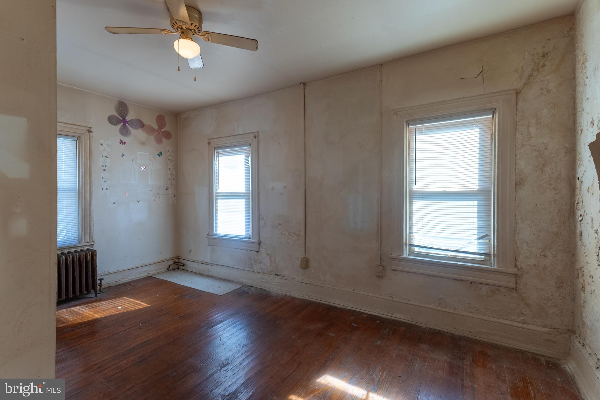5911 Crown Street Capitol Heights, MD 20743 - Photo 10 of 28 an empty room with wooden floor and windows