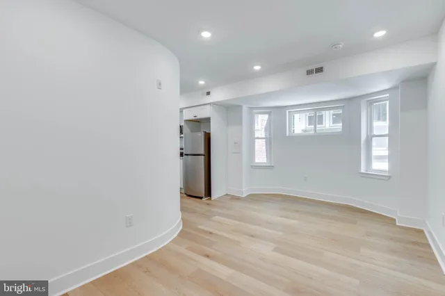 a view of a room with wooden floor and windows