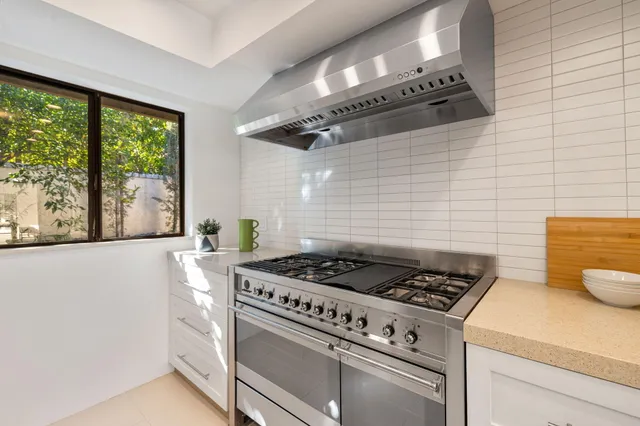 a kitchen with a stove and a white refrigerator