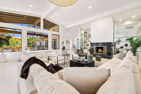 a living room with furniture fireplace and flat screen tv
