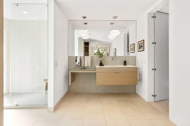 a view of a bathroom with a sink and mirror
