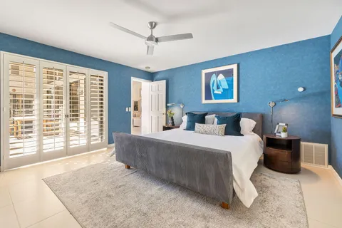 a spacious bedroom with a large bed and a large window