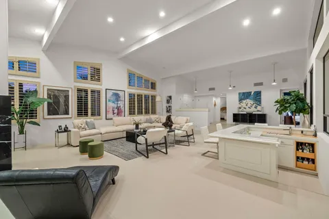 a living room with fireplace furniture and a large window