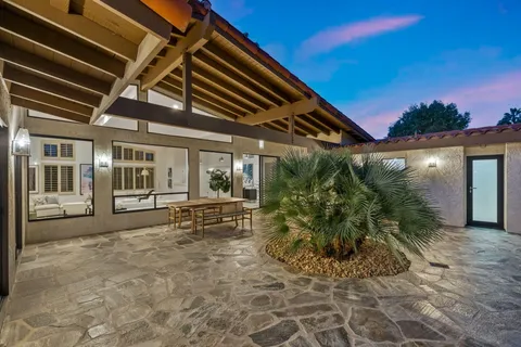 a view of house with backyard outdoor seating and plants