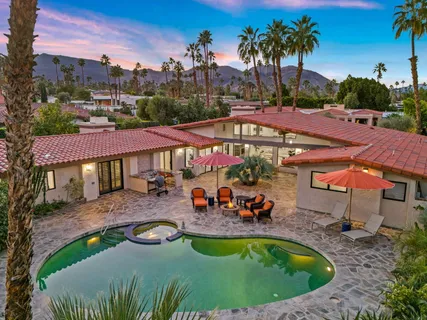 an outdoor space with swimming pool and furniture