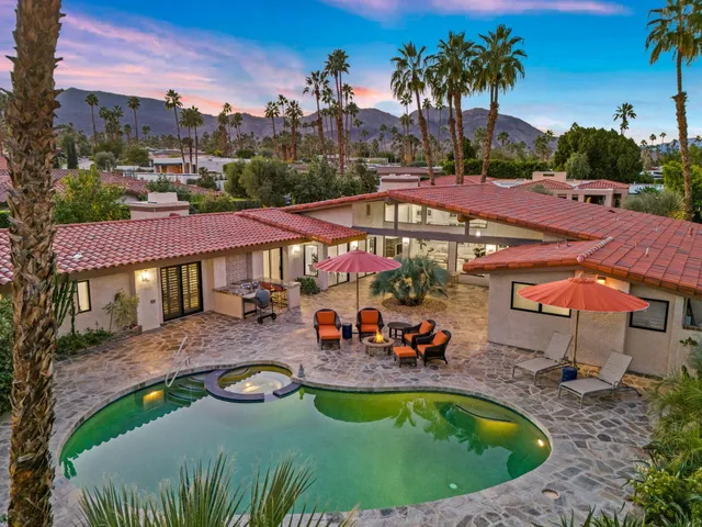 an outdoor space with swimming pool and furniture