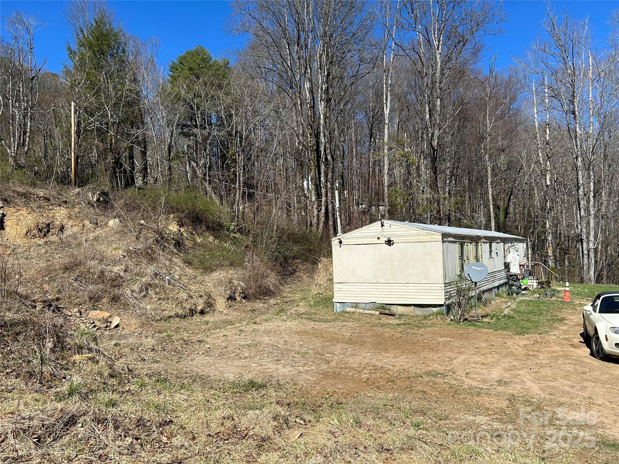 612 Heady Mountain Road Cashiers, NC 28717 - Photo 4 of 5 a white house that has a tree in front of it