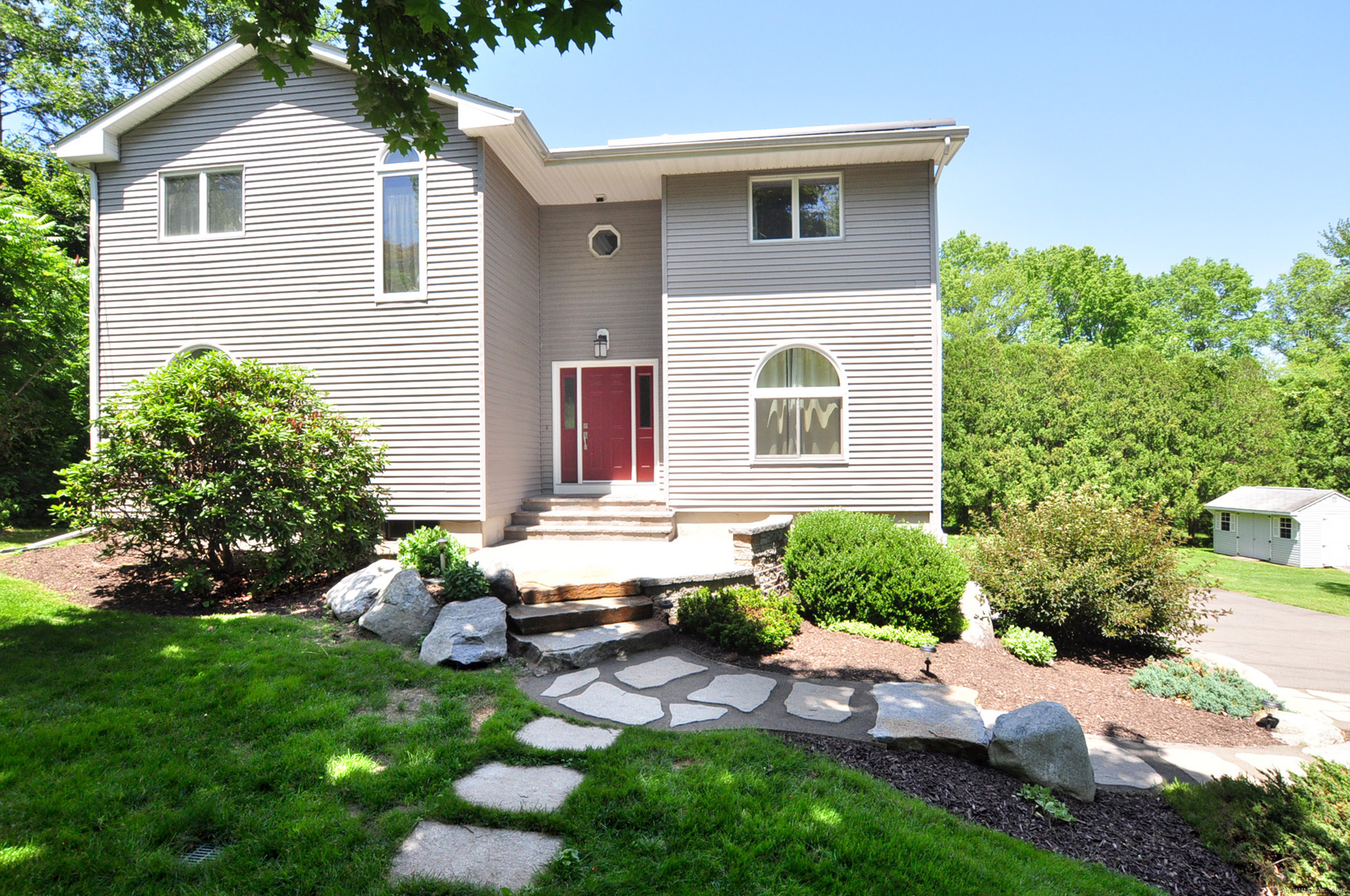 a front view of a house with garden