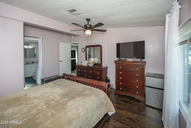 a bedroom with a bed and a flat screen tv