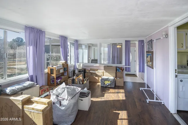 a living room with furniture and large windows