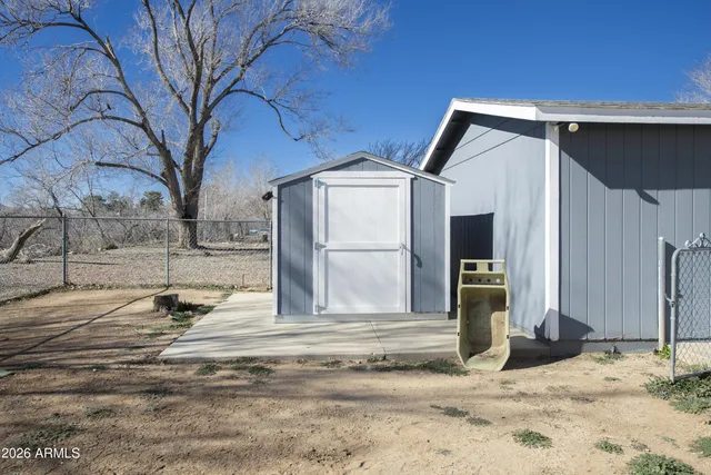 a white house that has a tree in front of it