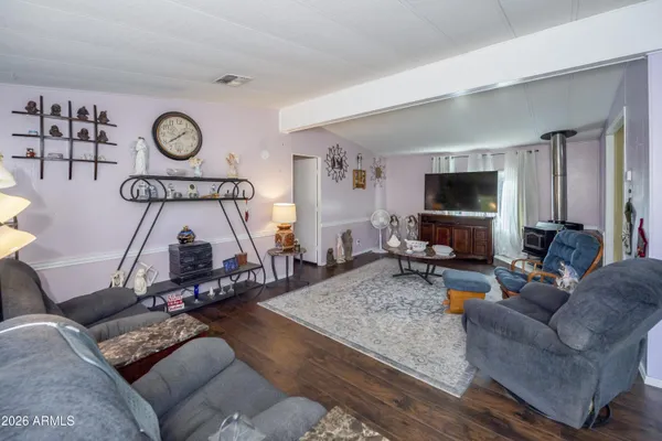 a living room with furniture a flat screen tv and a window