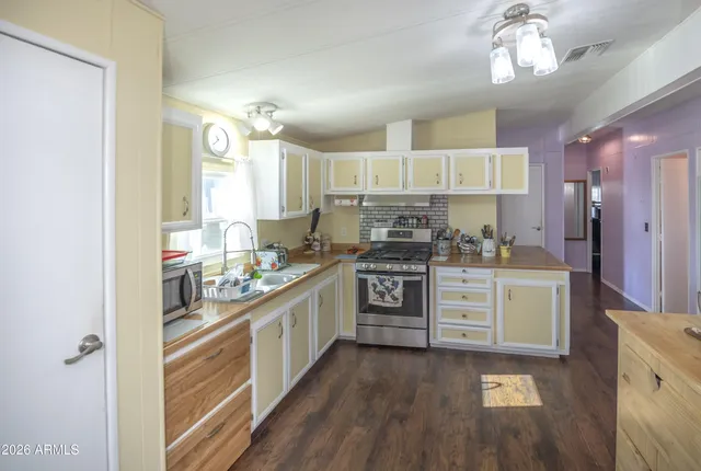 a kitchen with a white cabinets and chandelier
