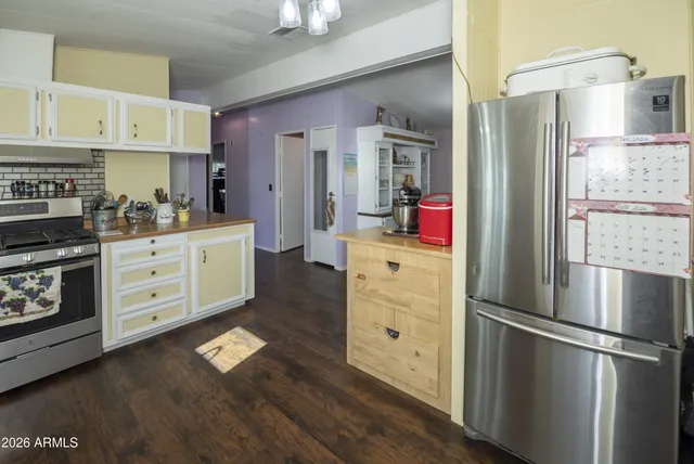 a kitchen with stainless steel appliances kitchen island granite countertop a refrigerator sink and cabinets