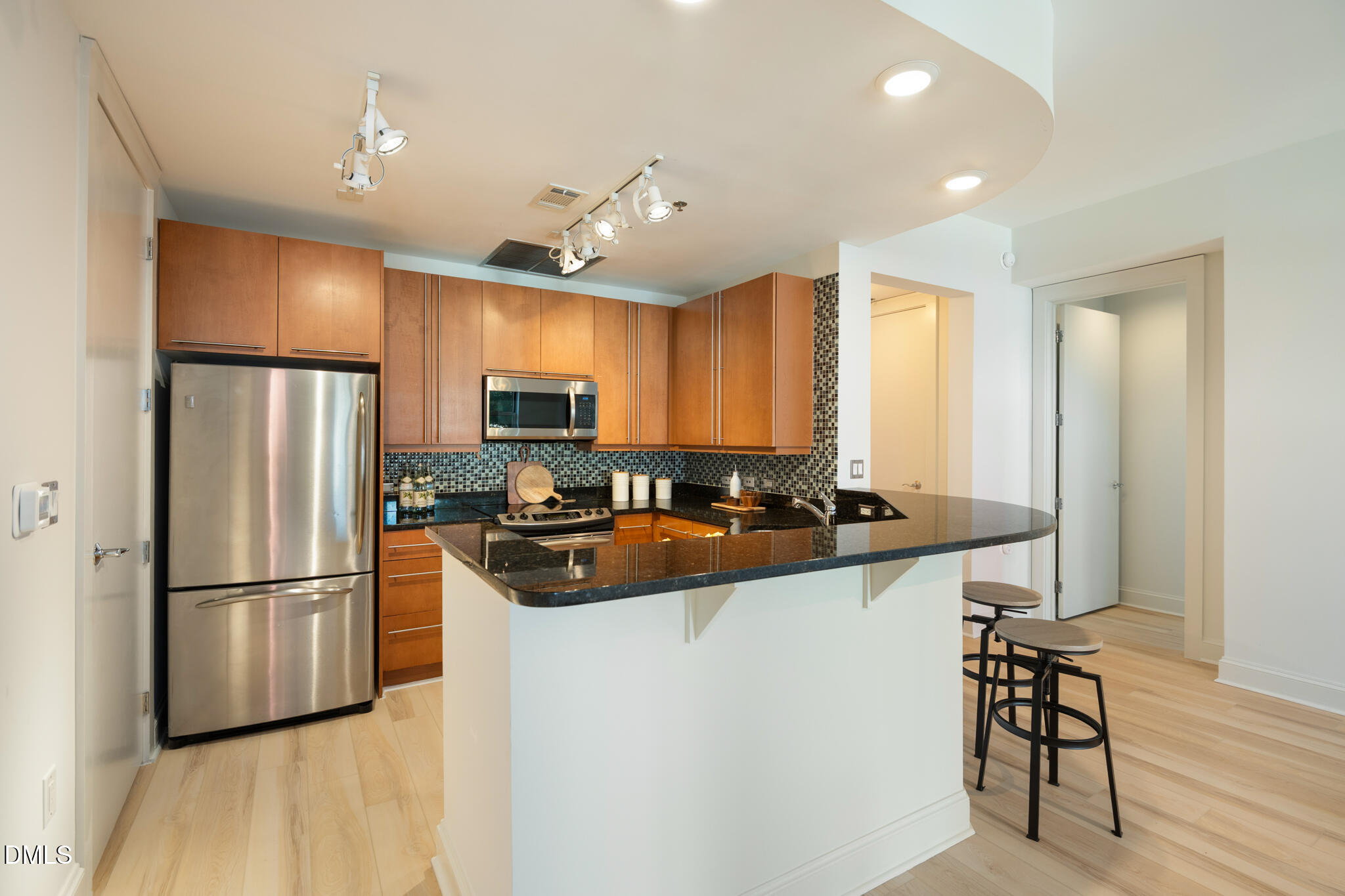 618 North Boylan Avenue, Unit 400 Raleigh, NC 27603 - Photo 10 of 45 a kitchen with stainless steel appliances granite countertop a refrigerator a sink a stove a dining table and chairs