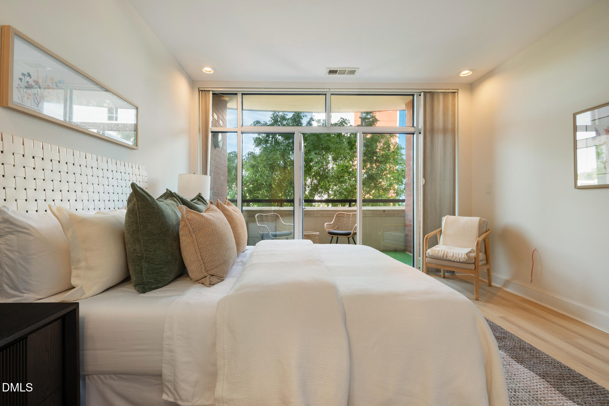 618 North Boylan Avenue, Unit 400 Raleigh, NC 27603 - Photo 14 of 45 a bedroom with a bed and glass window