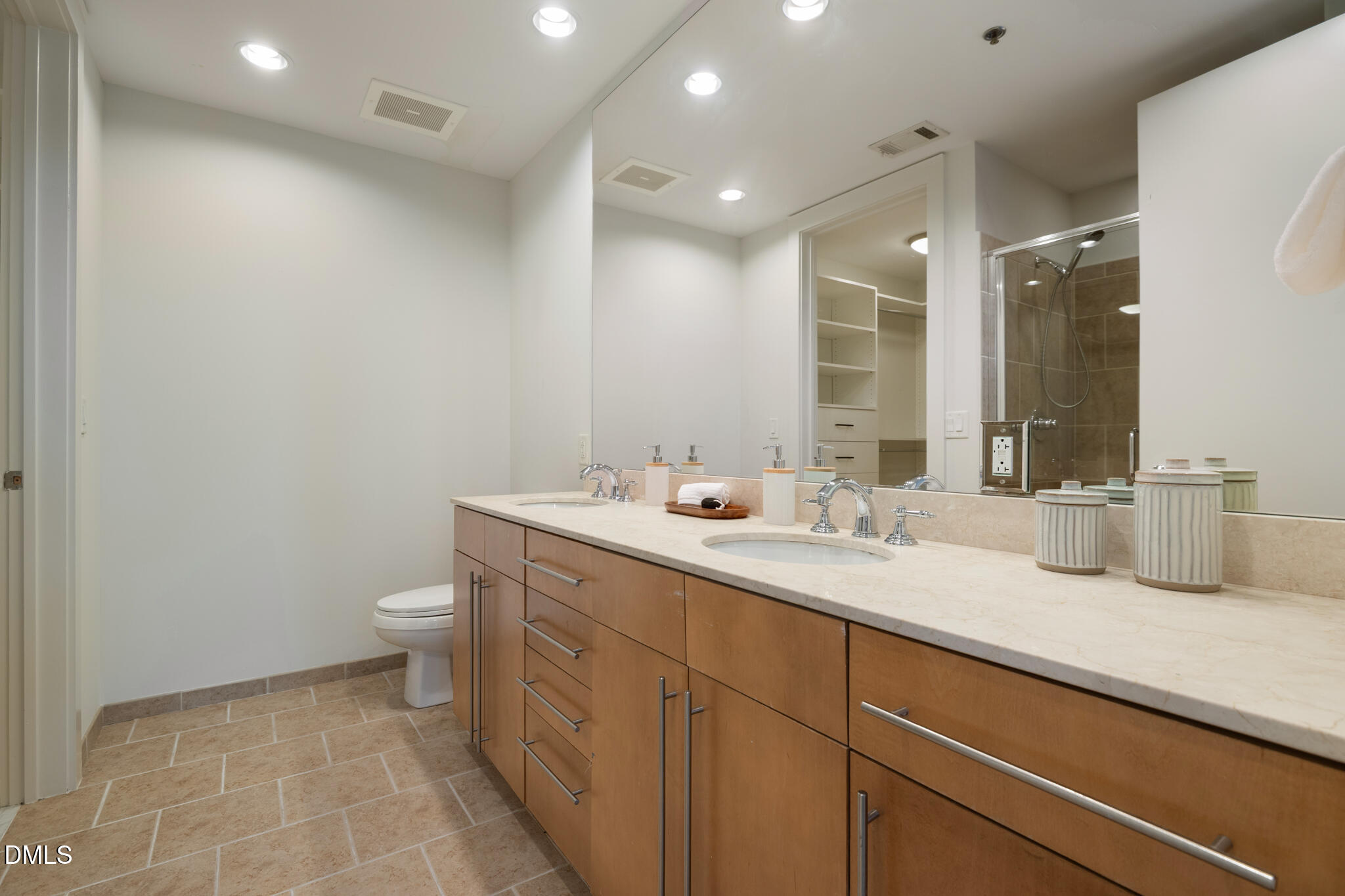 618 North Boylan Avenue, Unit 400 Raleigh, NC 27603 - Photo 31 of 45 a bathroom with a sink a toilet and a mirror