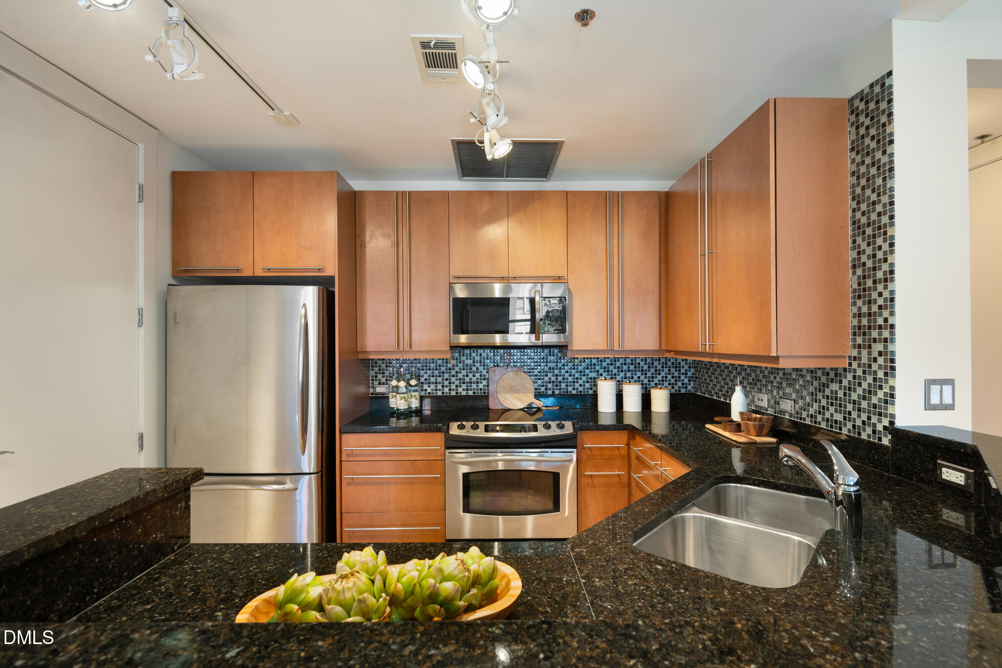 618 North Boylan Avenue, Unit 400 Raleigh, NC 27603 - Photo 7 of 45 a kitchen with granite countertop a sink stainless steel appliances and cabinets