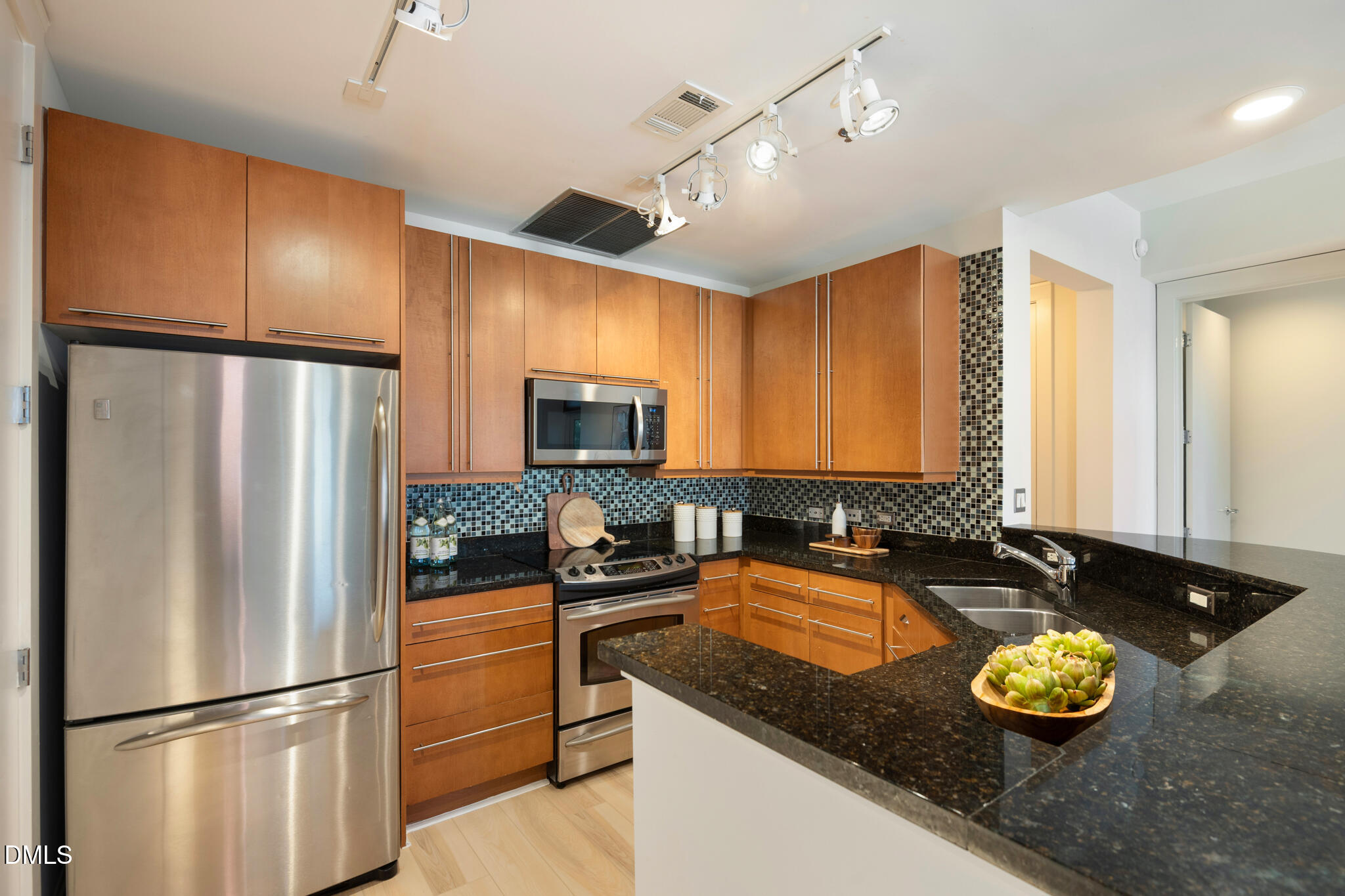 618 North Boylan Avenue, Unit 400 Raleigh, NC 27603 - Photo 8 of 45 a kitchen with granite countertop a refrigerator a sink and cabinets