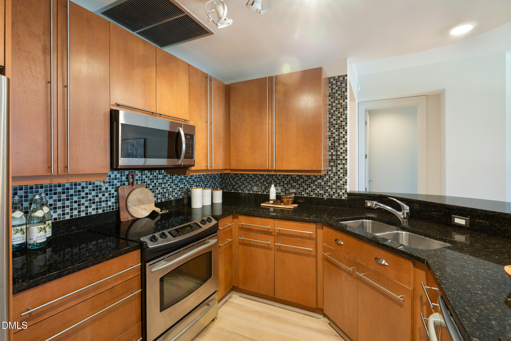 618 North Boylan Avenue, Unit 400 Raleigh, NC 27603 - Photo 9 of 45 a kitchen with granite countertop a sink and a stove top oven