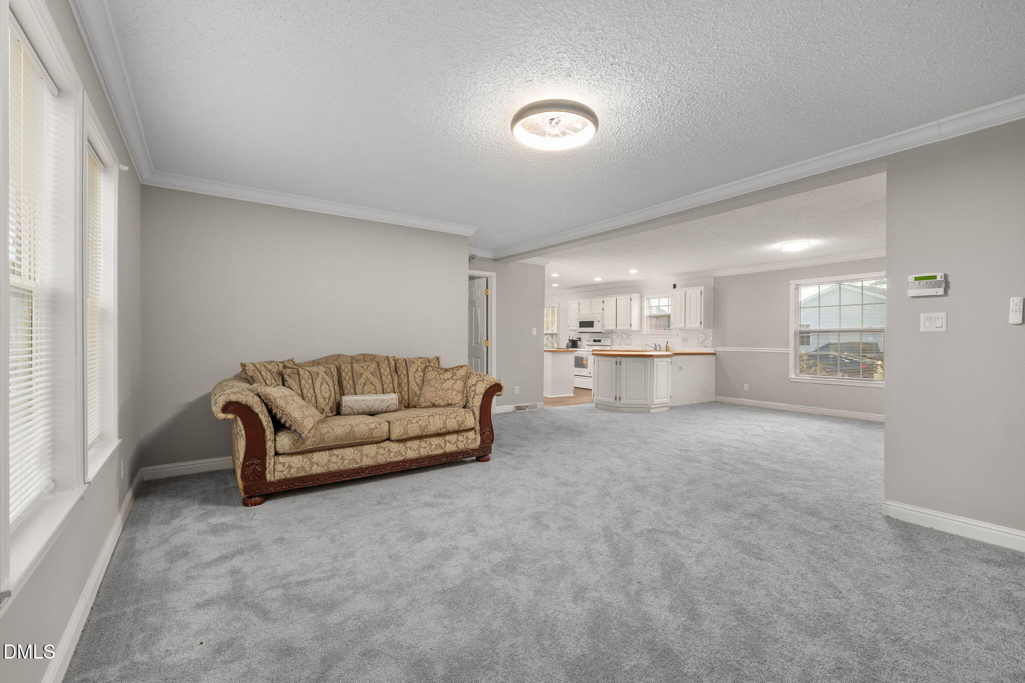 2850 Sanderford Road Raleigh, NC 27610 - Photo 11 of 34 a living room with furniture and a view of kitchen